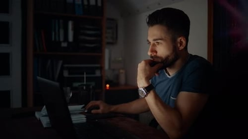 Man Working On Modern Office At Night. Overtime Work In Office.Overworked Businessman