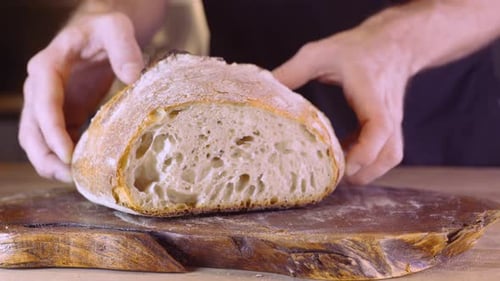 Man's Hands Move The Sourdough Bread On Wooden Board. - Slider, Close Up Shot