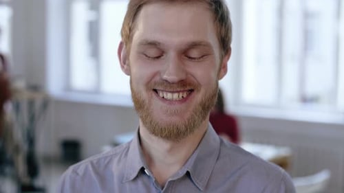 Close-up Portrait of Young Happy European Finance Businessman Cheerfully Smiling at Camera in Modern