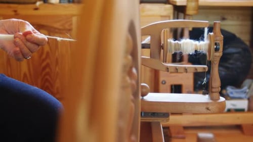 Senior woman operating weaving machine