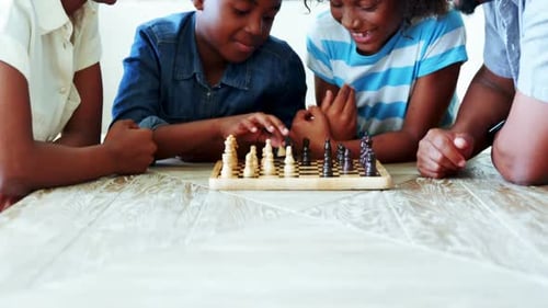 Happy Family Plays Chess Together Indoors
