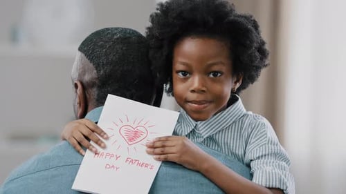 Girl Hugs Father and Presents Father's Day Card