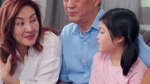 Family Sitting Together and Talking on Couch