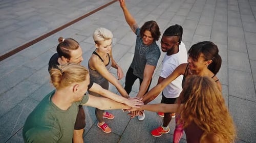 Team of Athletes Men and Women Stand in a Circle and Shake Hands