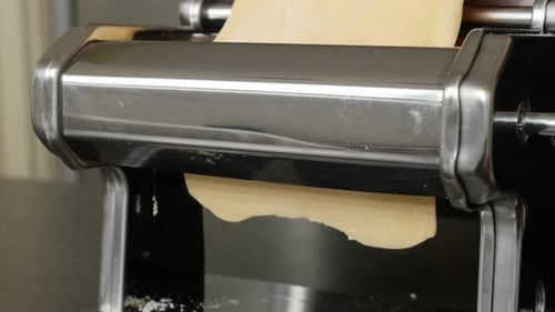 Dough processed in pasta machine close-up 4K 2160p 30fps UltraHD footage - Italian lasagna sheets m