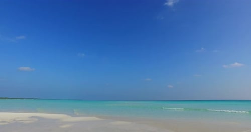 Daytime aerial abstract view of a sunshine white sandy paradise beach and aqua blue ocean background