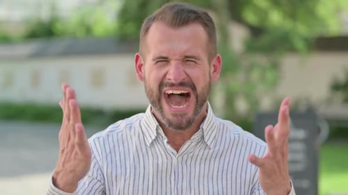 Man Yelling with Intense Emotion Outdoors