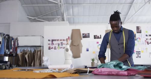 Mixed race man working in fashion office