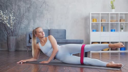 Blonde Woman Workout With Resistance Band Indoors