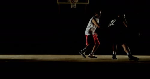 Competitors playing basketball in the court