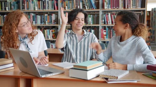 Excited People Students Doing Project in Library Then Doing High-five Laughing