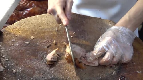 Chef of China restaurant is slicing roasted Peking Duck. Beijing, China.