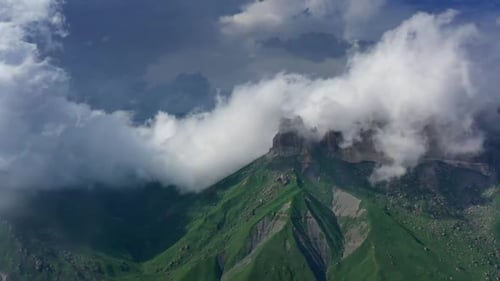 Aerial View of Green Mountain Peaks and Clouds