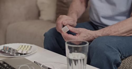 Mature Man Organizes and Takes Daily Medication