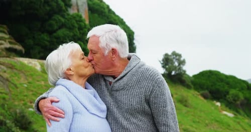 Senior Couple Sharing a Kiss in Nature