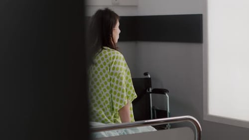 Asisstant with Dark Skin Checking Hospitalized Patient with Breathing Disorder