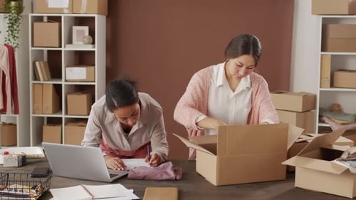 Women Checking Clothes Order in Office of Online Store