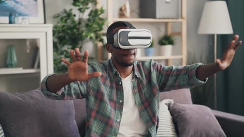 Man Immersed in VR Experience at Home