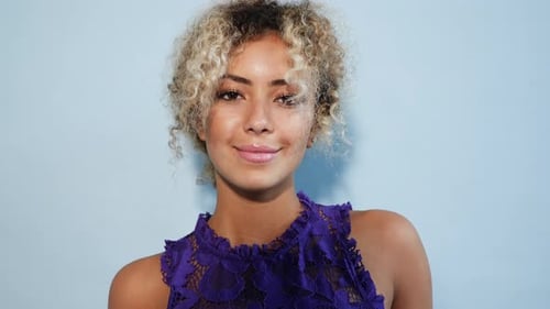 Beautiful black woman with afro blond hair. Girl smiling and looking on camera