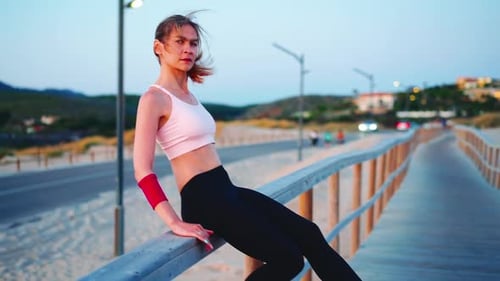 Fit Woman at Beach Boardwalk at Sunset