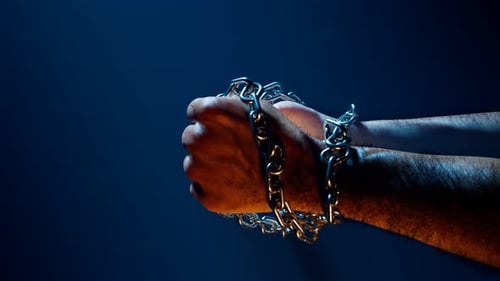Hands breaking chains. Metal or steel chain is blown to pieces. Break free.