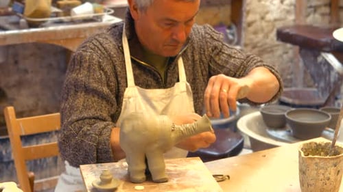 Craftsman Creates Clay Elephant Figurine in Workshop