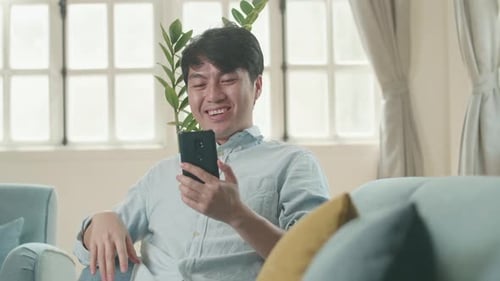 Young Man Chatting on Phone Indoors