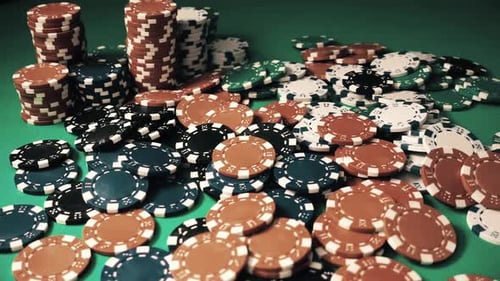Vintage Poker Chips Are Falling on a Green Gambling Table in Slow Motion