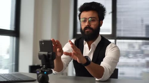 Indian Vlogger Business Man Putting Phone on Tripod and Sets Up Camera to Filming Video Tutorials on