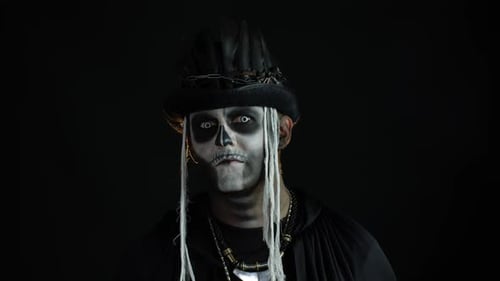 Man in Skeleton Makeup and Feathers Stares