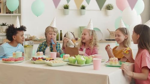 Kids Celebrating Birthday Party with Gifts and Treats