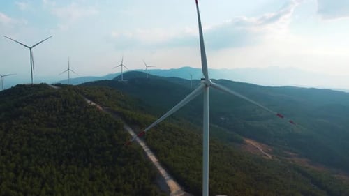 The windmills at the top of the hill generate clean green energy.