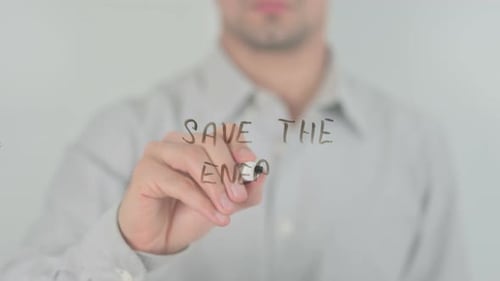 Man Writes 'Save the Energy' on Glass Surface