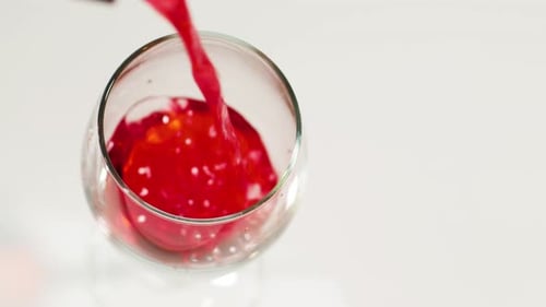 Pouring Red Liquid into Glass Overhead