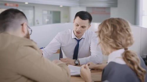 Professionals Talking Over Documents at Office Table