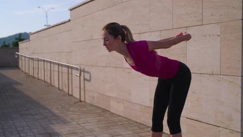 Workout in Morning Time Outdoors in City Young Woman is Doing Physical Exercises