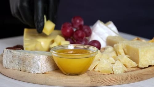 Variety of Cheeses with Grapes and Honey
