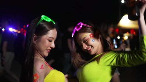 4K Group of Asian woman enjoy full moon beach party and dancing together.