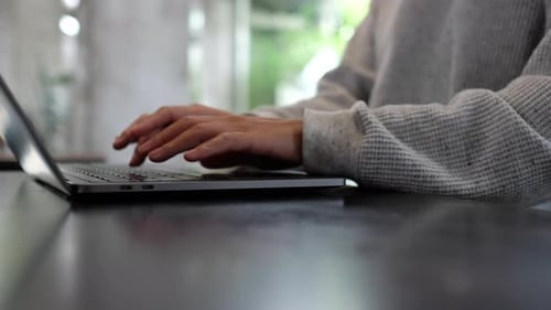 Person's Hands Typing on Laptop at Workplace