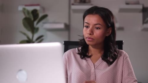 Young Woman Working at Home on Laptop