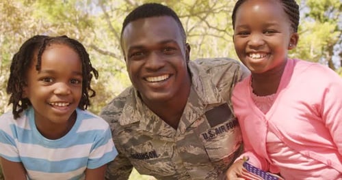Soldier and Children Smiling Together in the Sunshine
