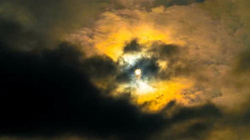Sun Glimmers Through Thick Dark Clouds Time-Lapse