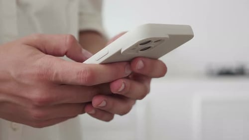 Women's Hands Holding the Phone Close Up