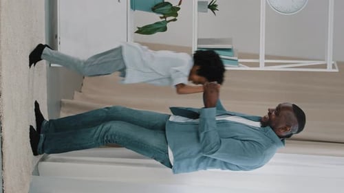 Vertical Video African American Father Having Fun with Little Daughter Dynamic Moving Dancing