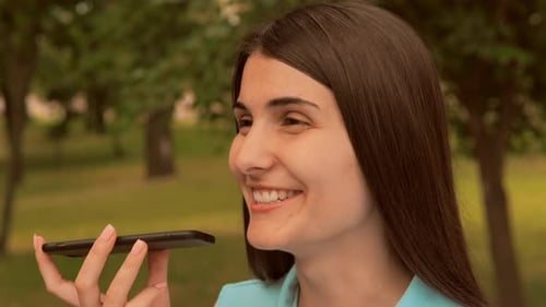 Close Up Face Cheerful Young Woman Speak Send Sound Message By Mobile Outdoors