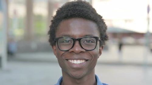 Close Up of Young African Man Smiling at Camera Outdoor