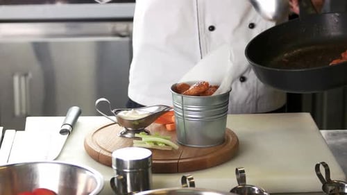 Chef Prepares Chicken Wings in Professional Kitchen