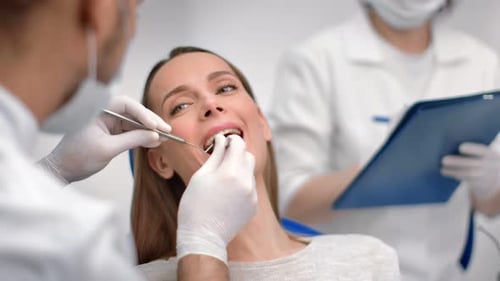 Woman Receives Dental Checkup in Bright Clinic