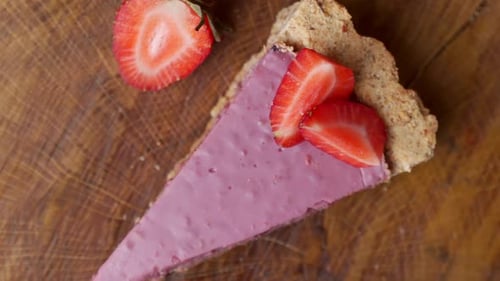 Top View of Fresh Strawberries with a Slice of Strawberry Cheesecake Rotate