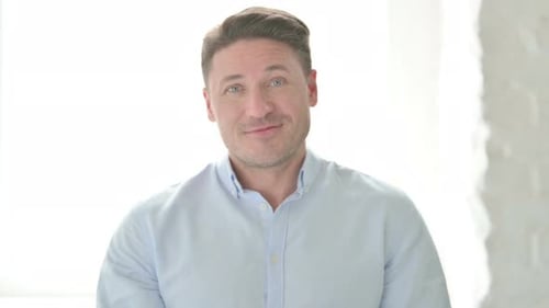 Man Talking to Camera in Bright Studio